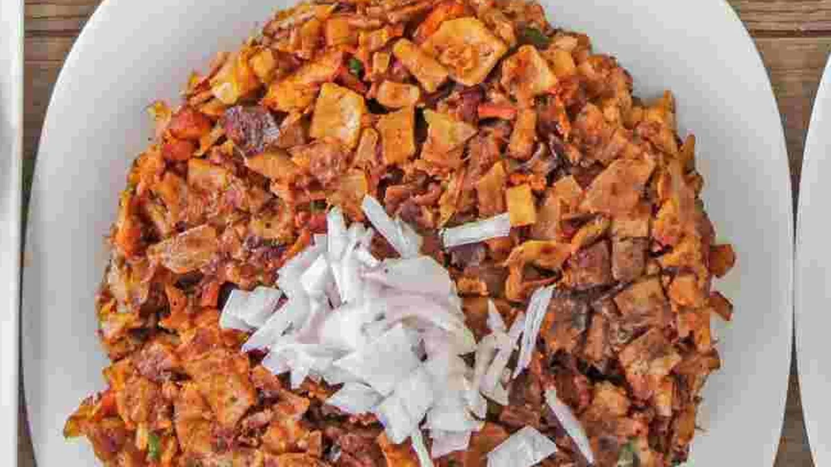 Kothu roti, chopped roti stir-fried with vegetables, topped with chopped onion